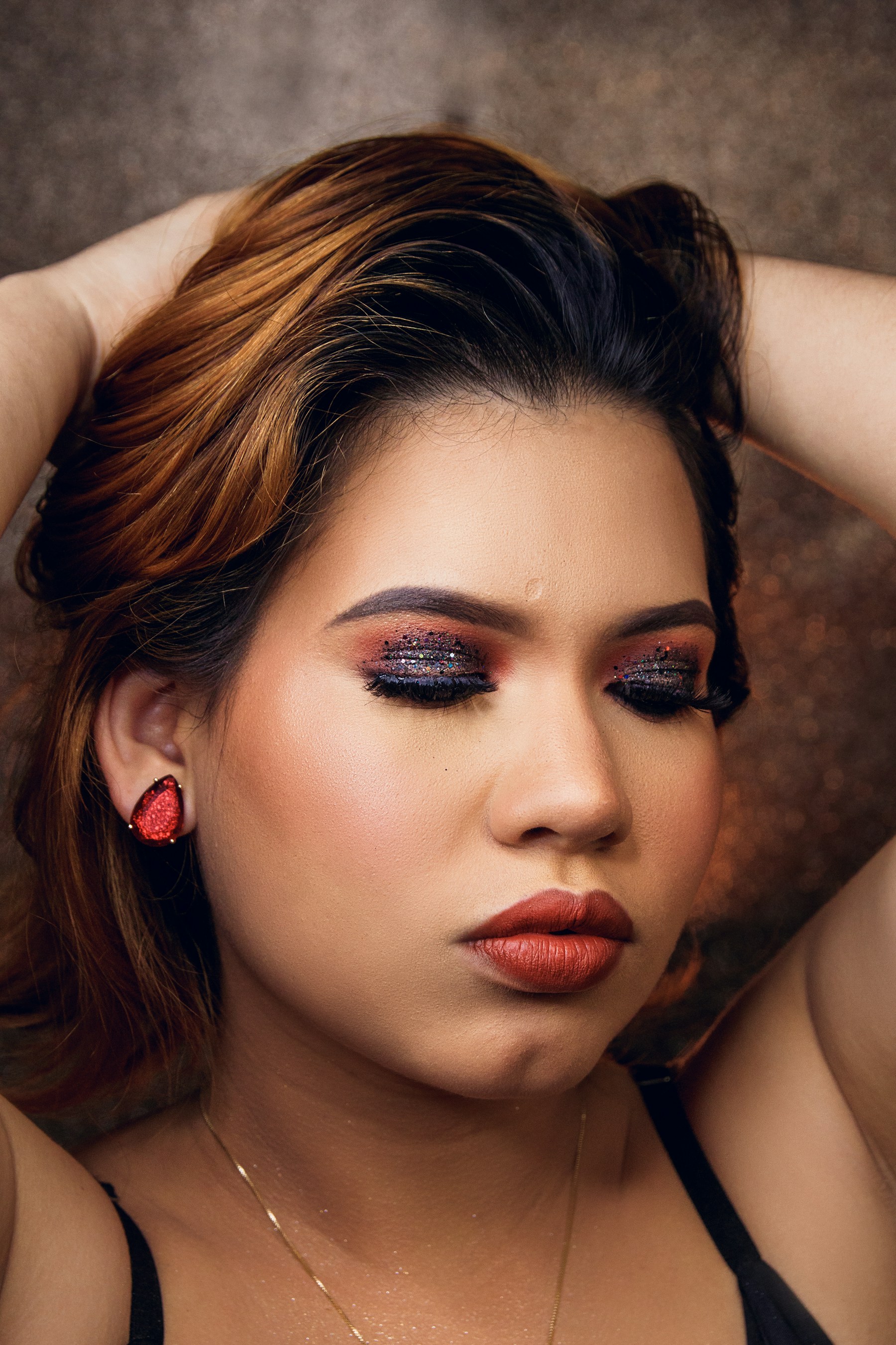 A beauty portrait with shimmering dark eye makeup and red lipstick