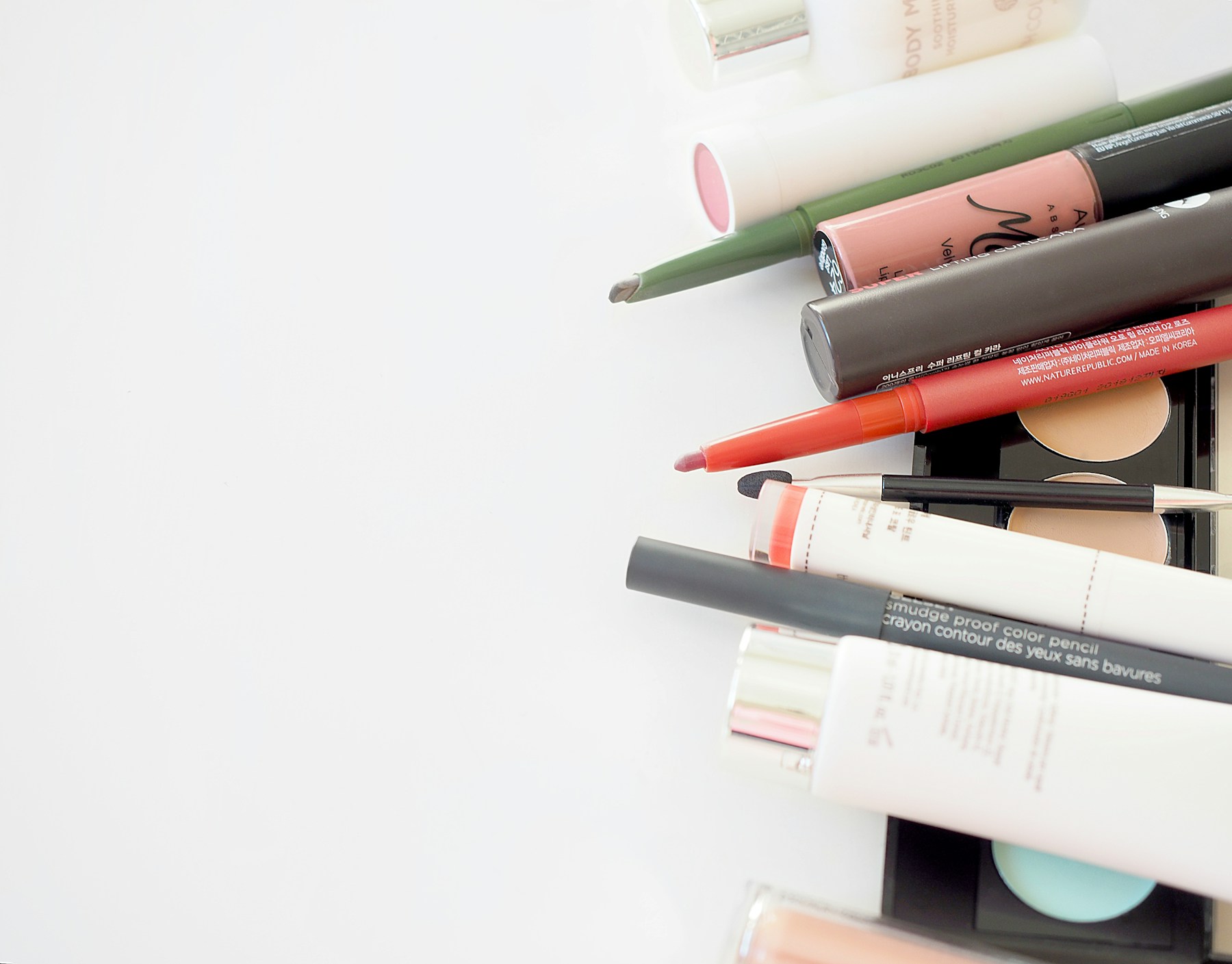An assortment of makeup products including lipstick, pencils and complexion cosmetics